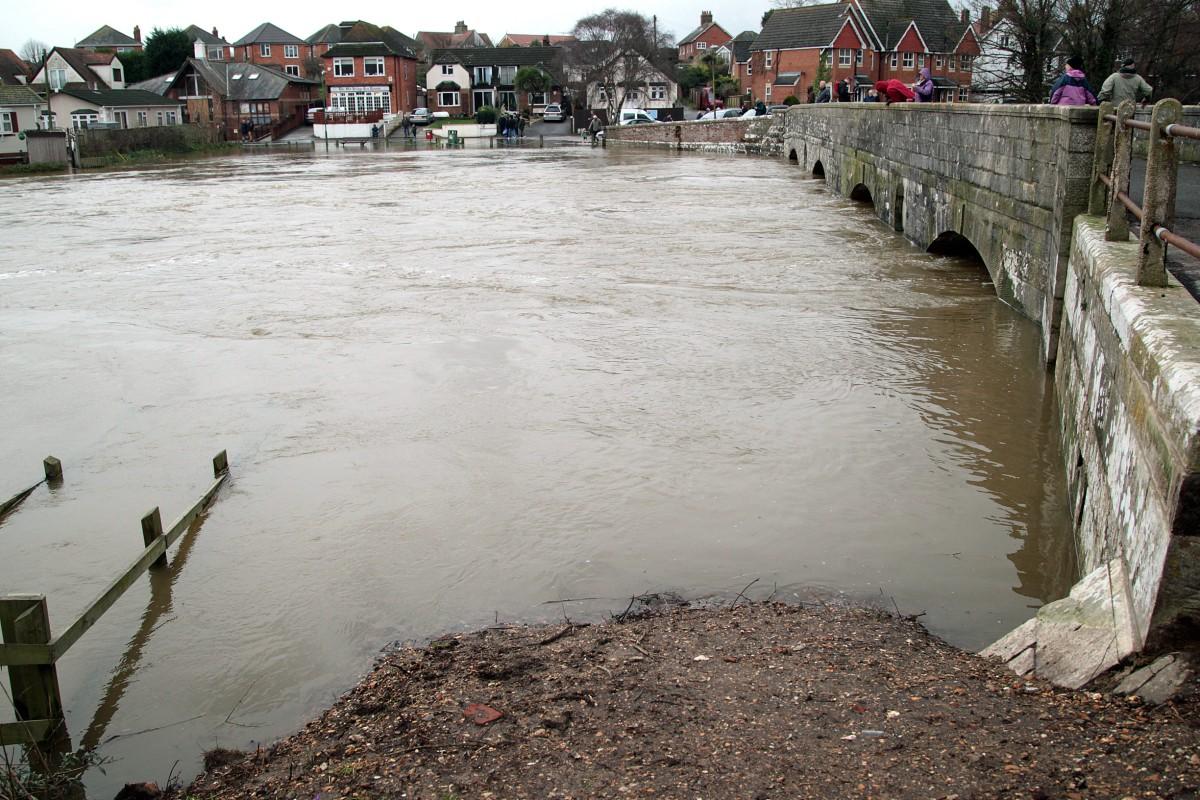 Heavy rain and strong winds cause flooding and high tides across Dorset. Flooding at Iford Bridge.