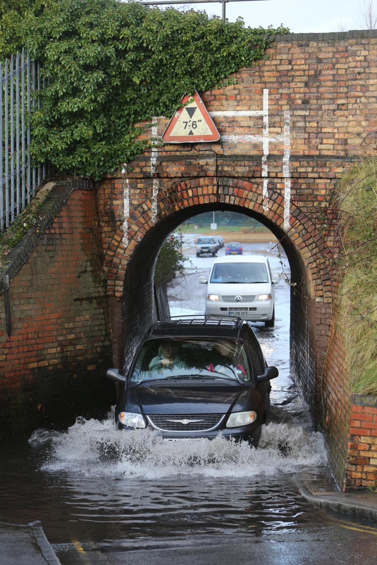 Heavy rain and strong winds cause flooding and high tides across Dorset. Motorists driving through the flooded tunnel under the railway line in Whitecliff Road  