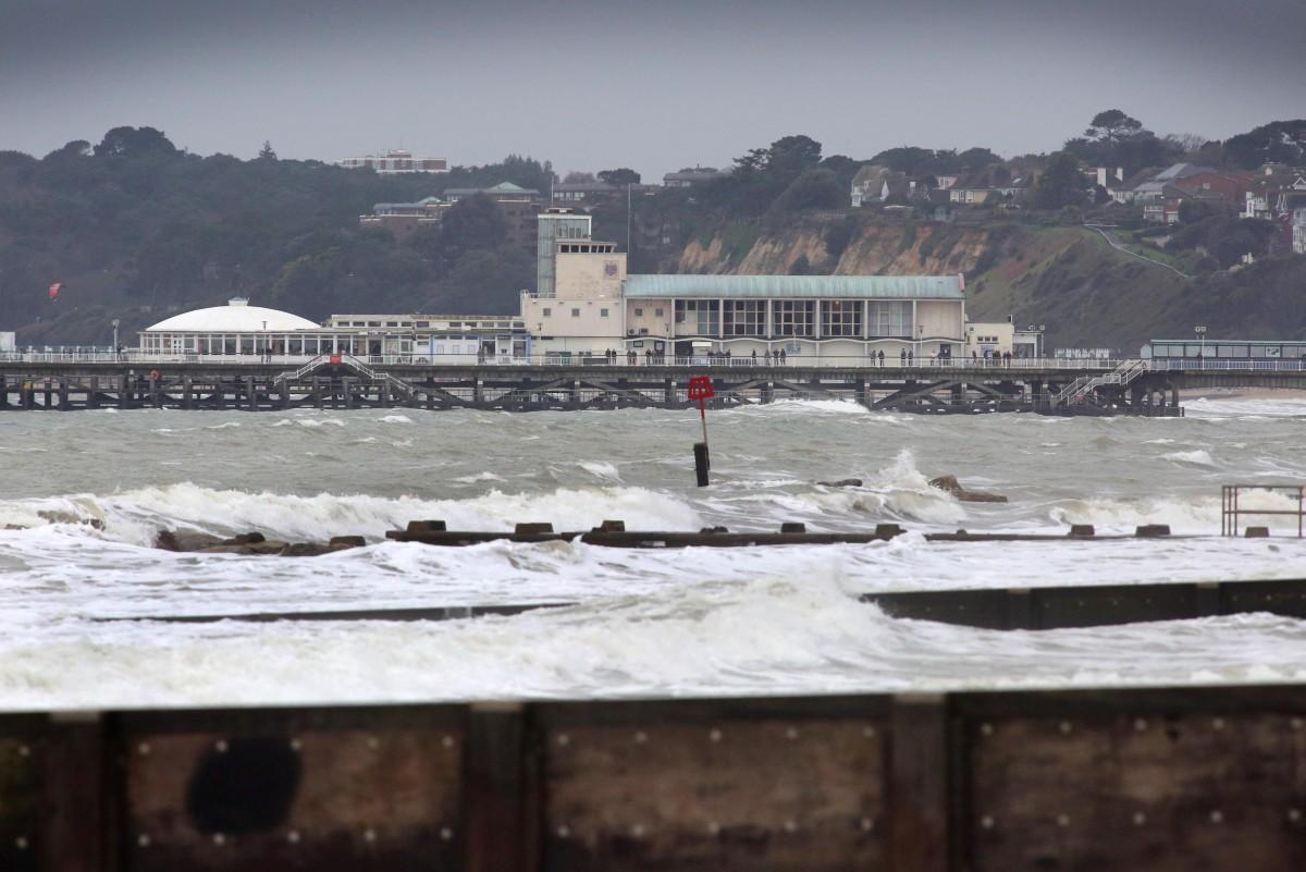 Heavy rain and strong winds cause flooding and high tides across Dorset. Rough seas  and Bournemouth Pier.