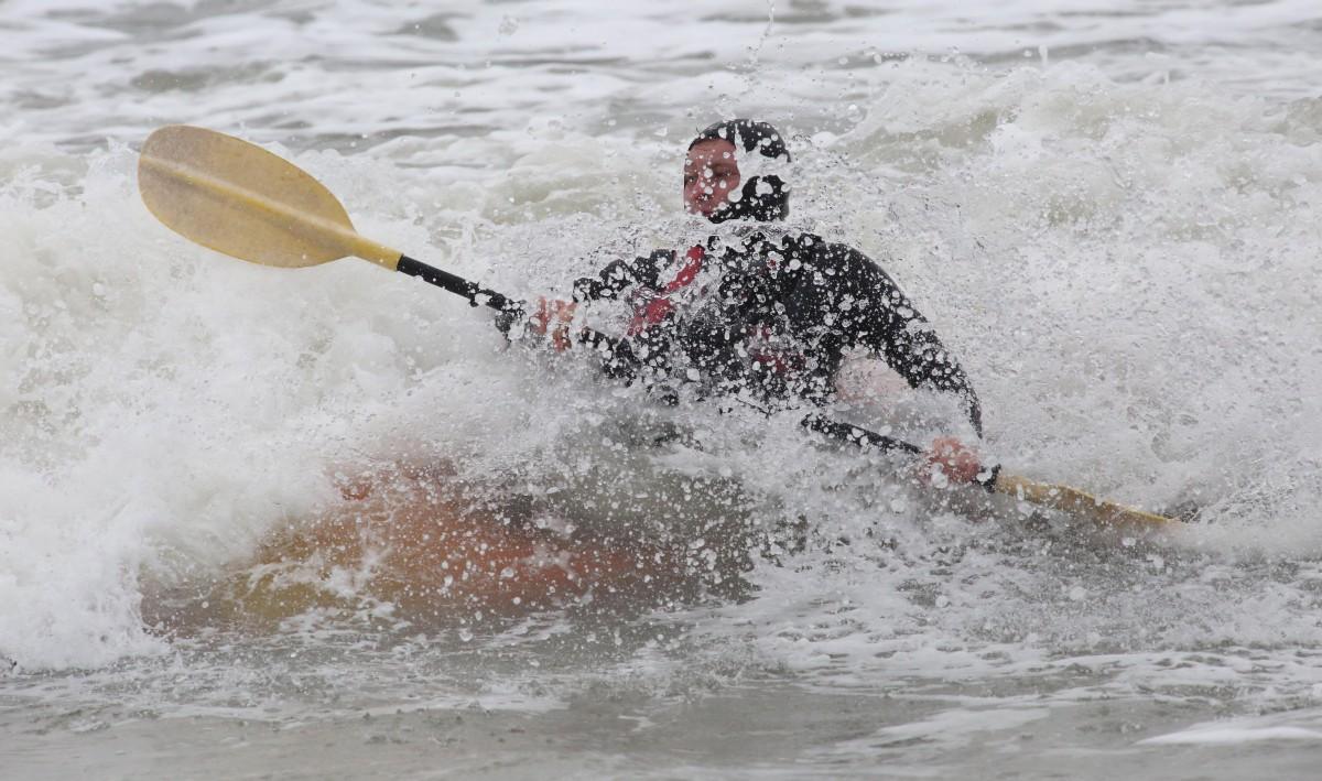 Heavy rain and strong winds cause flooding and high tides across Dorset. Kayakers enjoy the surf at Boscombe beach. Matthew Coope