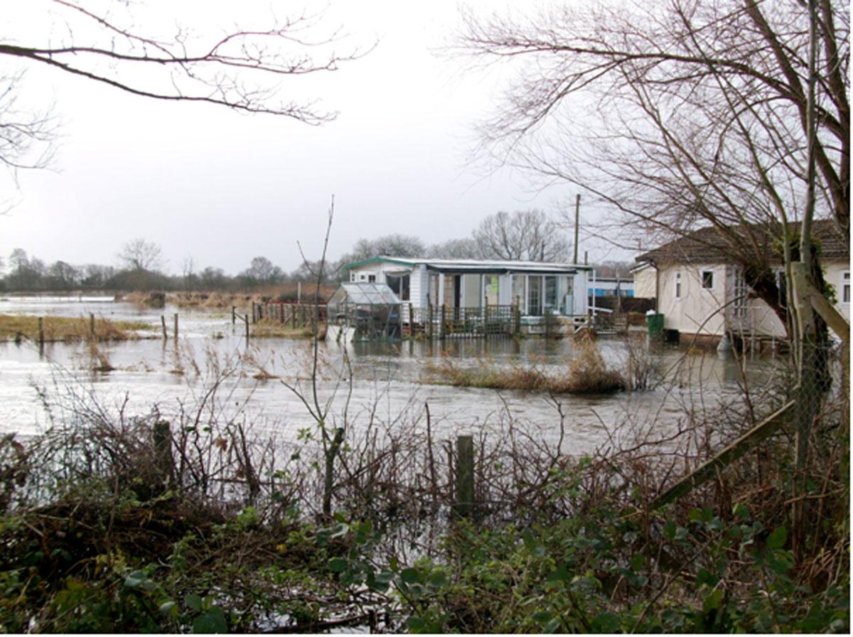 Daily Echo photographers and readers braved the stormy weather to capture these moments across Dorset. Floodwater surrounds a mobile home in Ringwood. Picture by Tim Baber.