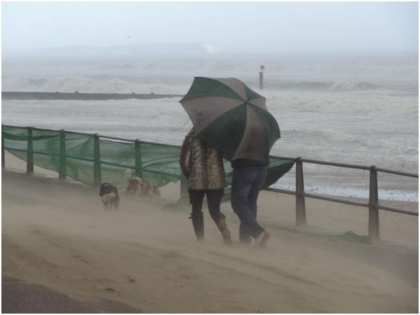A couple taking a walk on a very sandy Boscombe beach. Picture by Paul Godier. 