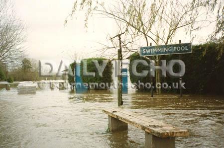 The Blandford outdoor swimming pool near a flooded Ham car park after the River Stour burst its banks in December 1992.