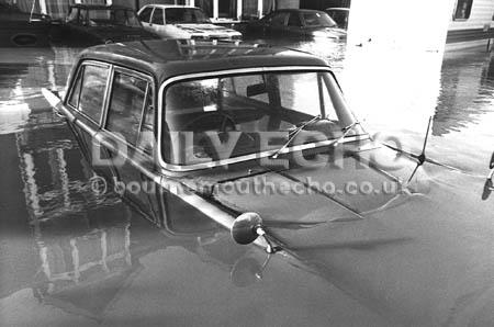 A car is partially submerged in flood waters at Christchurch after the 1979 storm.