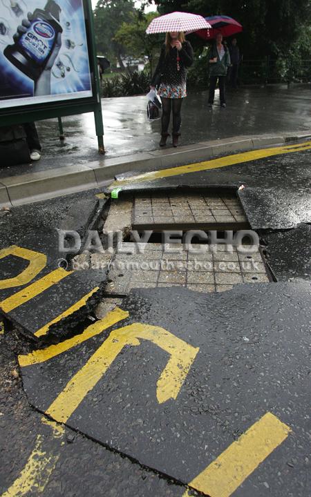 Flash floods hit Bournemouth town centre. 
The force of water in the drains blew the road apart by this bus stop. 