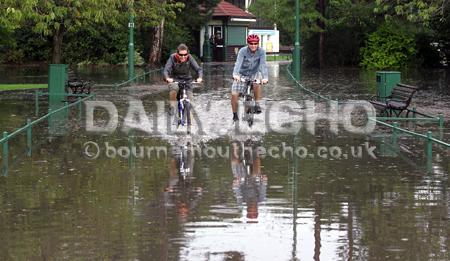 Flash floods hit Bournemouth town centre. 
Cyclists enjoy the challenge of riding through the flooded lower gardens. 