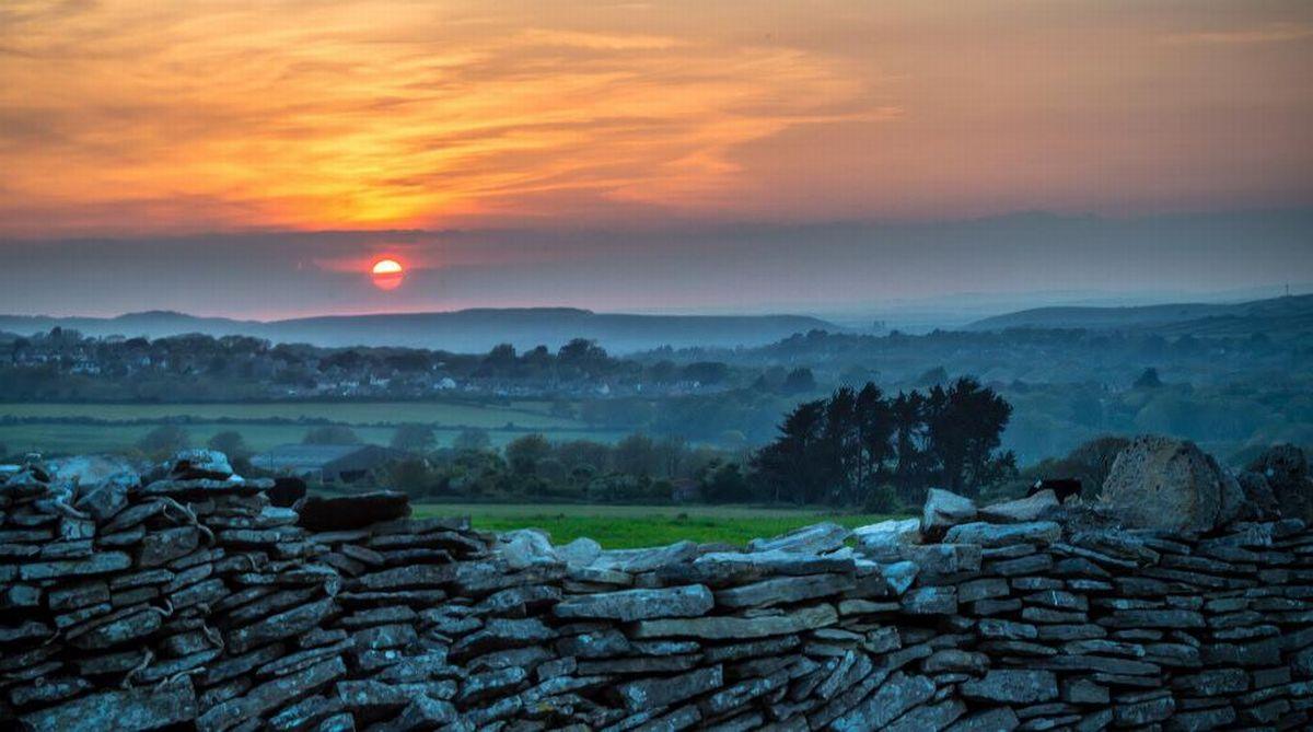 Picture by Andy Lyons of sunset from Swanage looking towards Corfe Castle