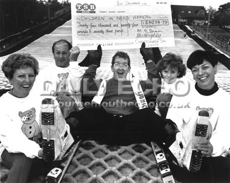 Eddie eagle an olympic flop was more of a hit with children in need when he received a cheque from Christchurch ski centre. org. date 1991.