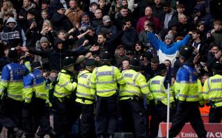 Police officers attempt to contain trouble between rival fans during West Brom’s FA Cup fourth round tie against Wolves (Bradley Collyer/PA).