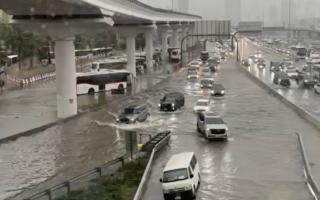 Cars driving through flood water in Dubai.