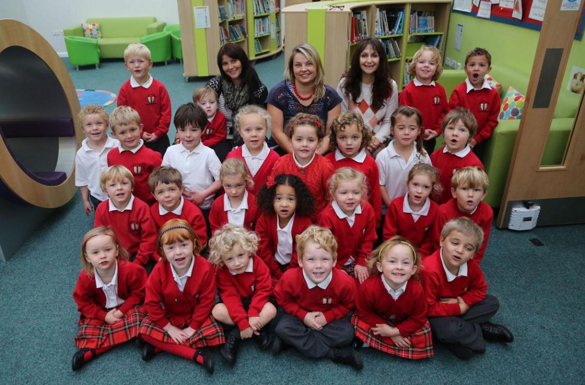 Reception class pupils at Lilliput Infants School with, left to right, TA Sarah Fawcett, teacher Kelly Smith and TA Lynette Webb.
