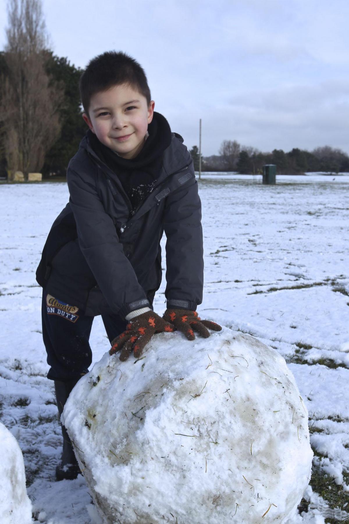 Christopher Bernal, aged 6, building a snowman at Baiter Park. Picture by Sam Sheldon