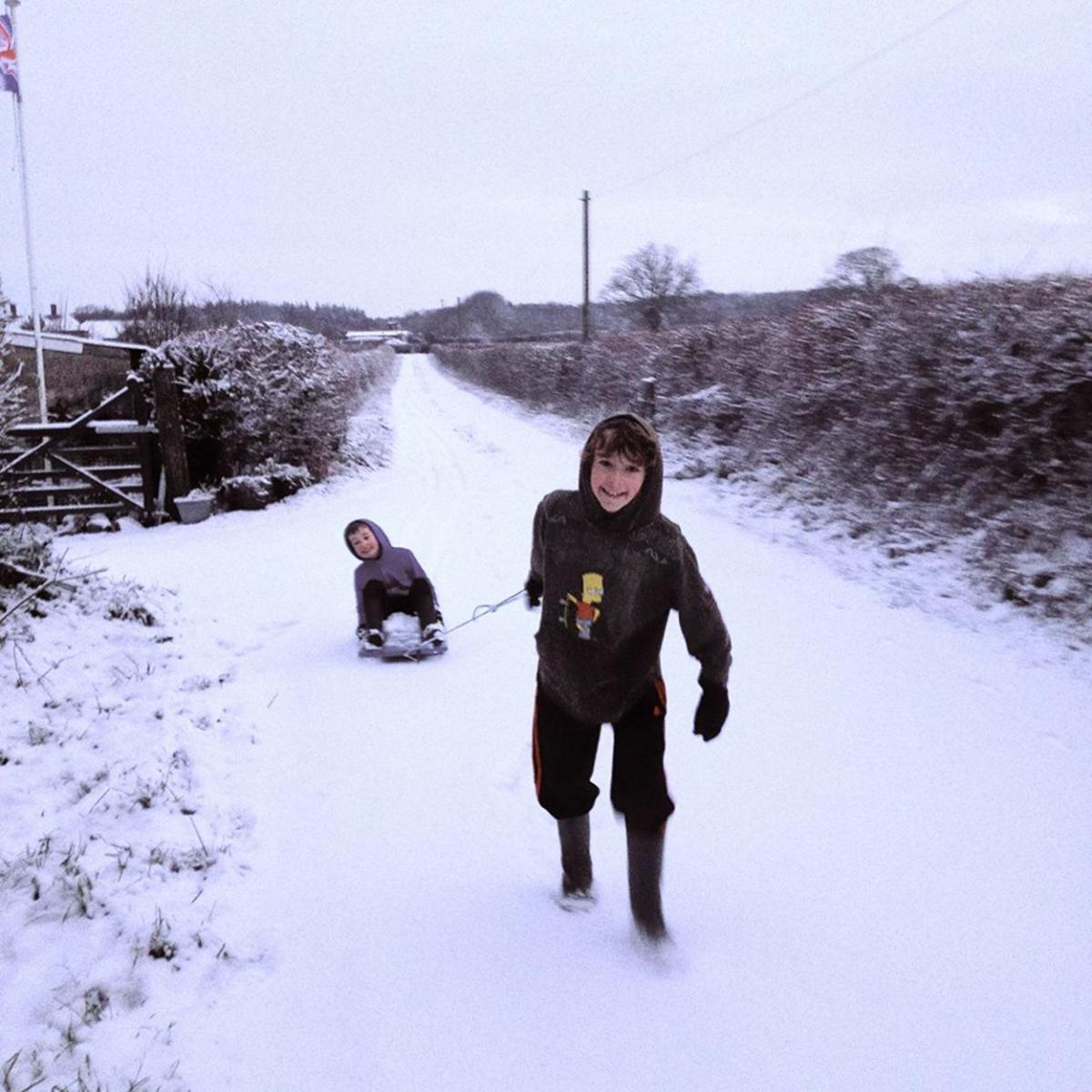Ben and Jamie Luther enjoying the  snow on Hill Farm, Lytchett Minster.  Picture by Michelle Luther