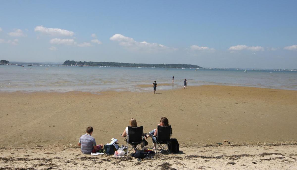 While it  was a  very busy day on Sandbanks Beach in Poole, one family  found  themselves  their own private beach  in the inner harbour  off Banks Road.