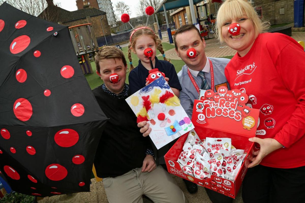 Staff from Sainsbury's Poole present Old Town First School pupil Isla Horobin,5, with her Red Nose goody bag after she won first prize in the school's drawing competition.