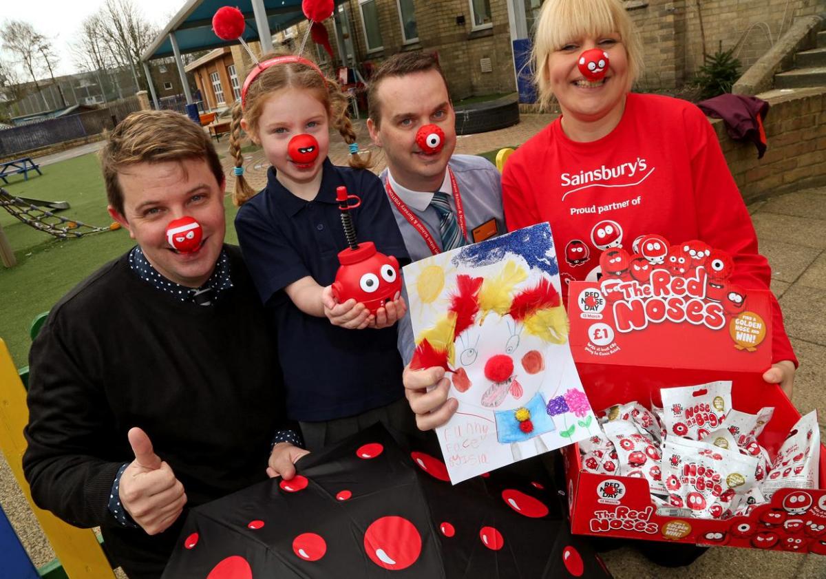 Staff from Sainsbury's Poole present Old Town First School pupil Isla Horobin,5, with her Red Nose goody bag after she won first prize in the school's drawing competition. 