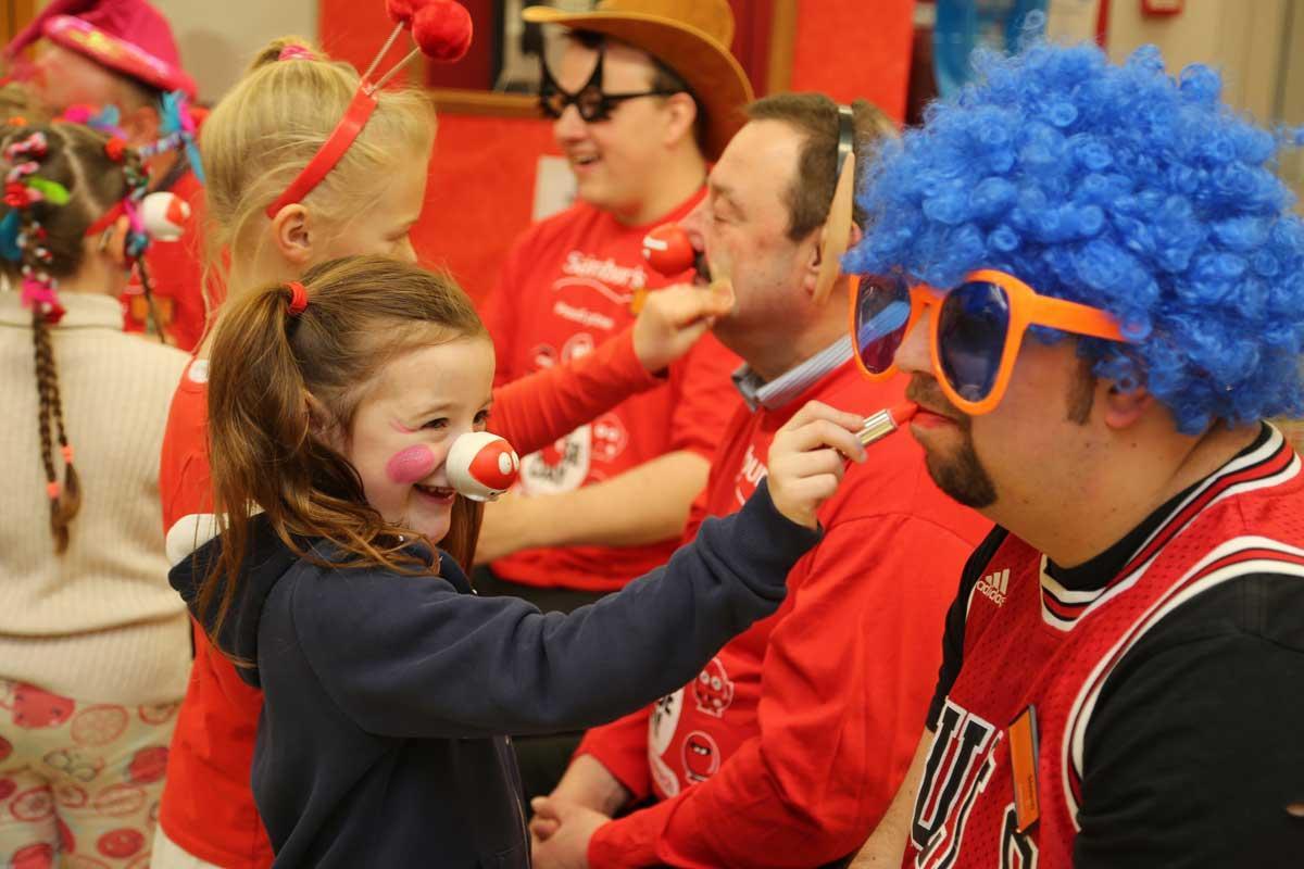 Old Town Infants pupils paint the faces of managers at Sainsburys in Poole