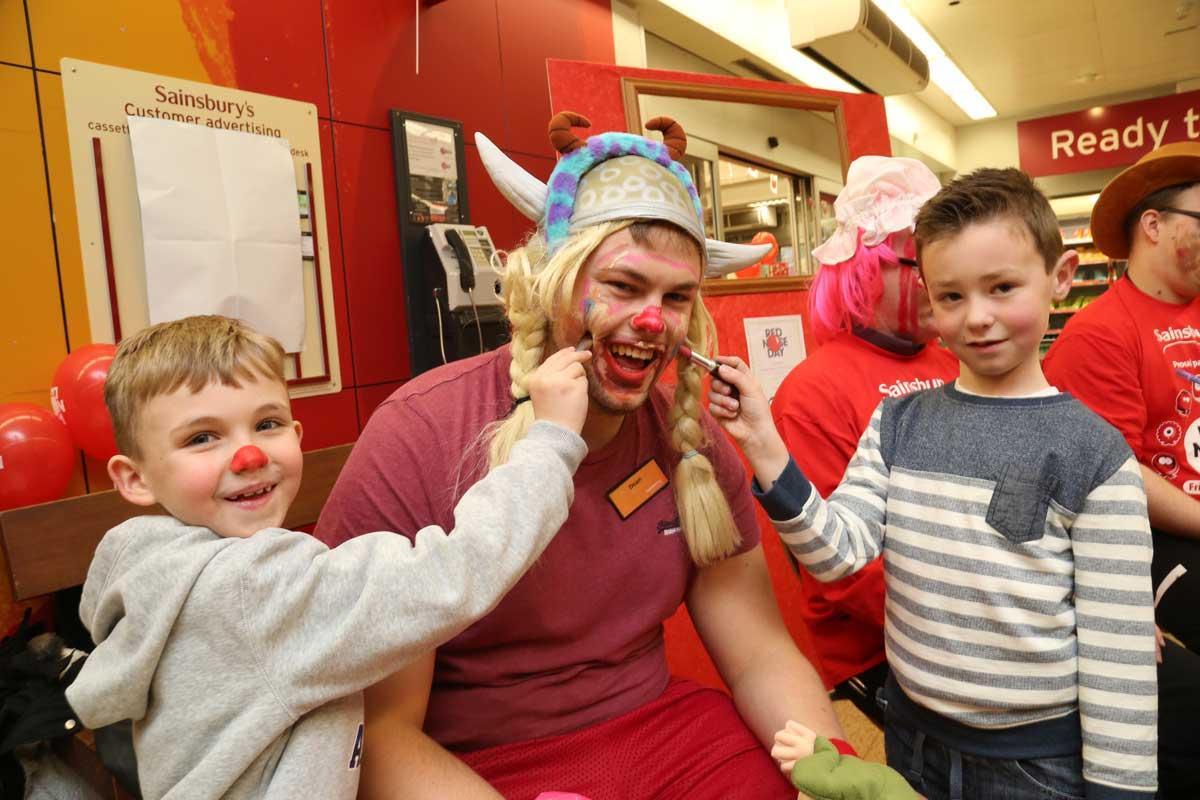 Old Town Infants pupils paint the faces of managers at Sainsburys in Poole