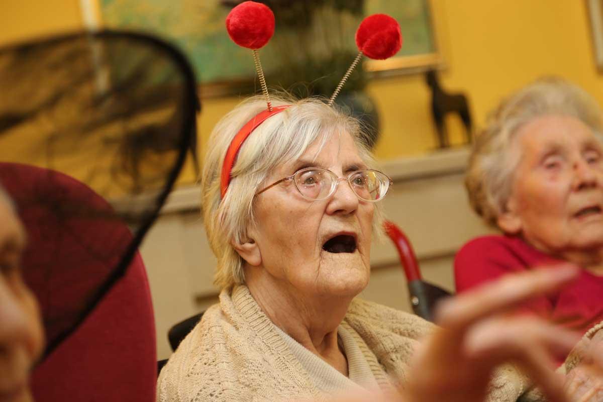 Residents at Avon Cliff care home take part in a  Mad Hatter's tea party for Comic Relief led by  Activity organiser Brian Knight.