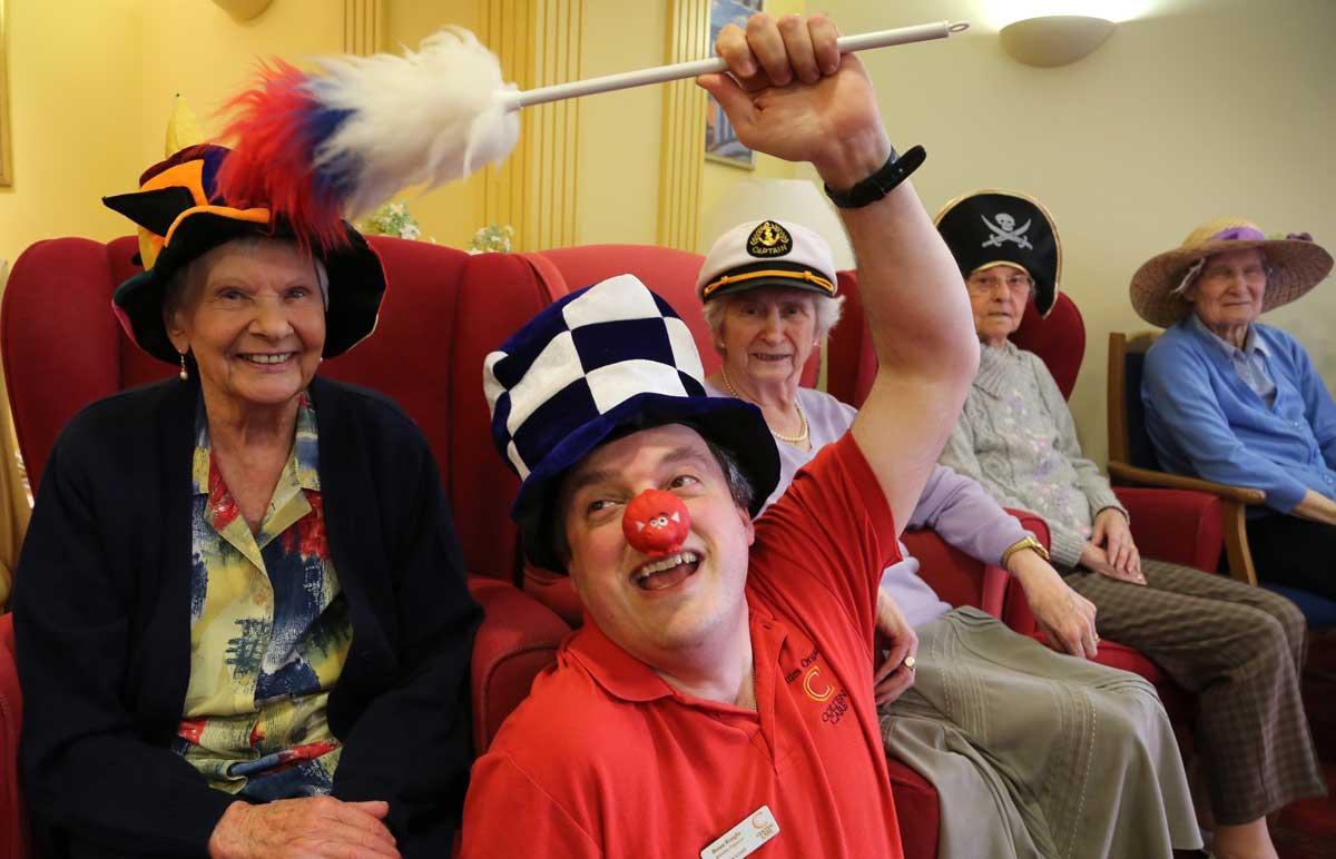 Residents at Avon Cliff care home take part in a  Mad Hatter's tea party for Comic Relief led by  Activity organiser Brian Knight.