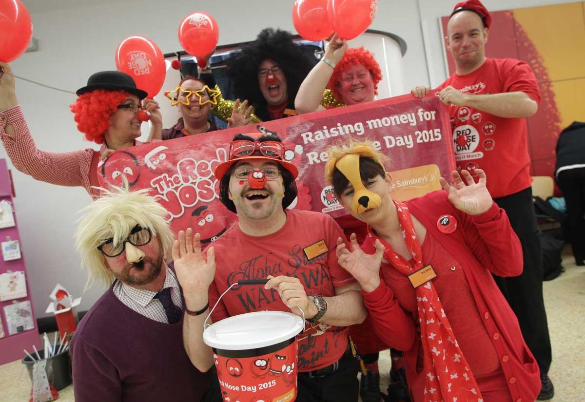 Staff at Sainsbury's Talbot Heath raising money for Comic Relief with a photobooth and face painting. 