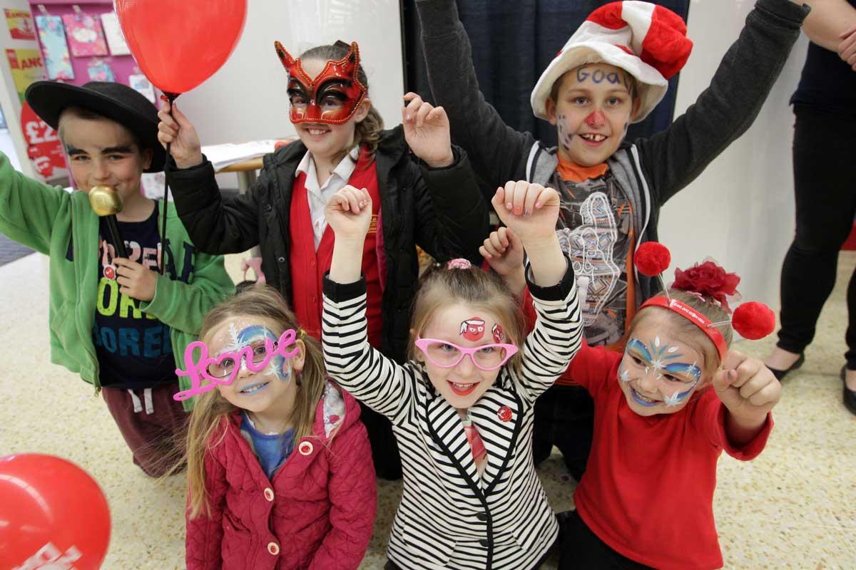 Staff at Sainsbury's Talbot Heath raising money for Comic Relief with a photobooth and face painting. 