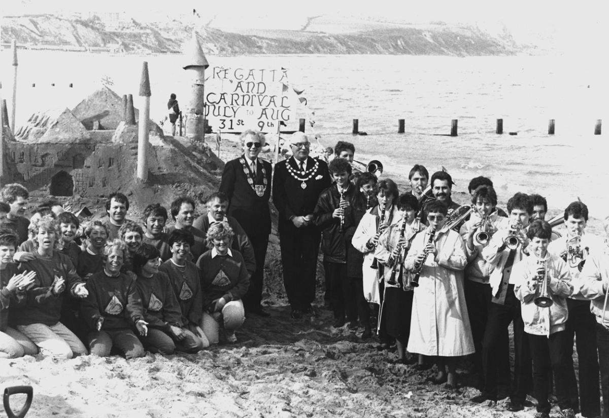 A giant sandcastle depicting a Rhineland castle, built by members of the Swanage Regatta and Carival committee (left) welcomed the twinning visitors in 1987. The German band who attended the twinning ceremony are seen, right, with Burgermeister Dr hubert 