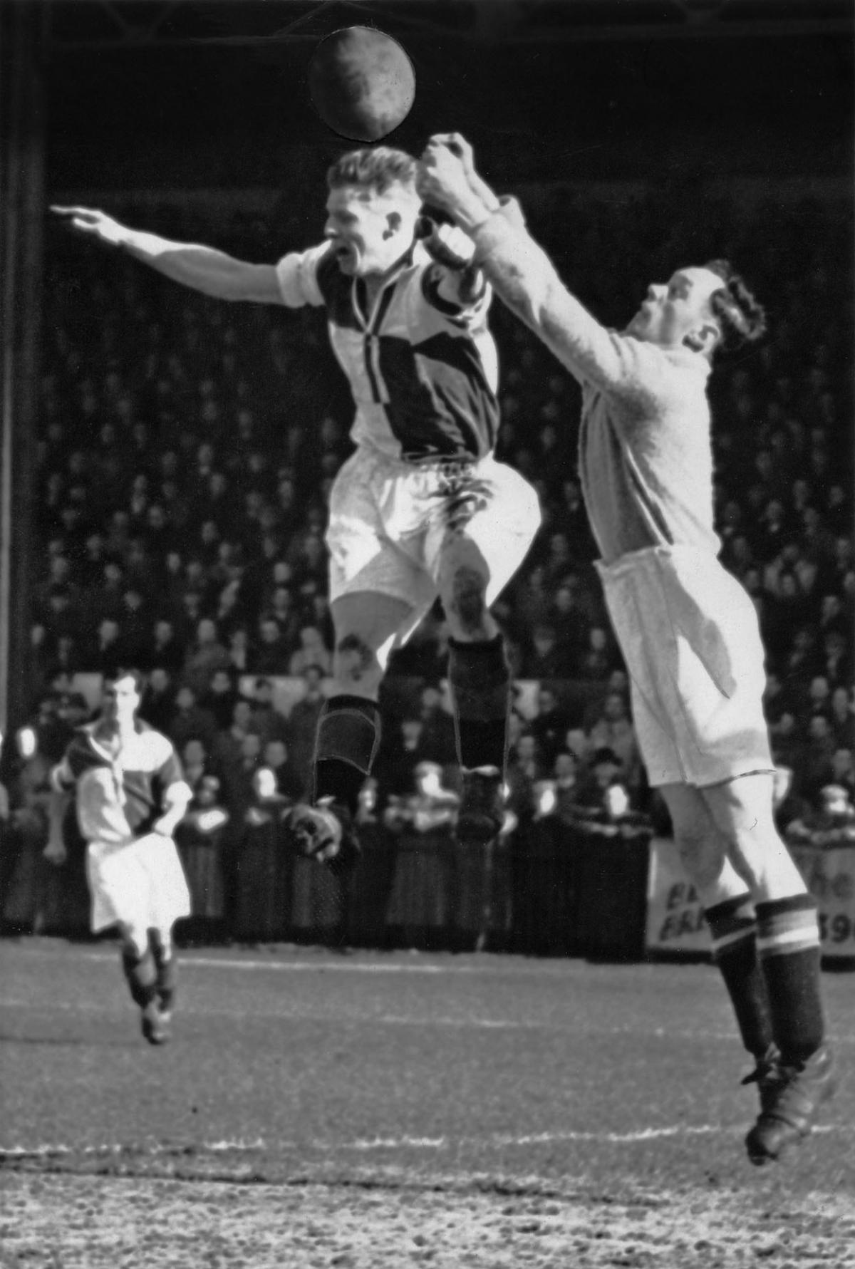 John Meadows, Boscombe's goalkeeper, making a double-fisted clearance over the head of Roost, Bristol Rovers' inside-left. 14 Mar 1951.
A selection of the images that are featured in the Daily Echo, AFC Bournemouth Photographic Book.