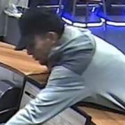 Man leaned over counter and stole cash from betting shop staff member