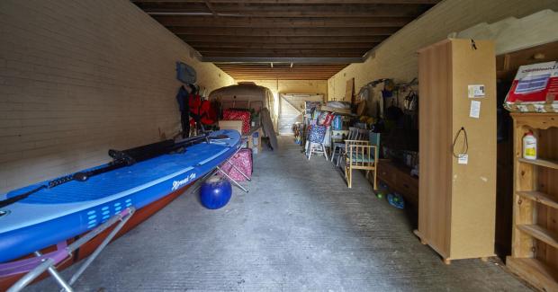 Bournemouth Echo: BNPS.co.uk (01202) 558833. 
Pic: LloydsPropertyGroup/BNPS

Pictured: The spacious interior of the garage. 

A run-down garage on the exclusive Sandbanks peninsula has sold for over £600,000 - 2.5 times the price of the average house in
