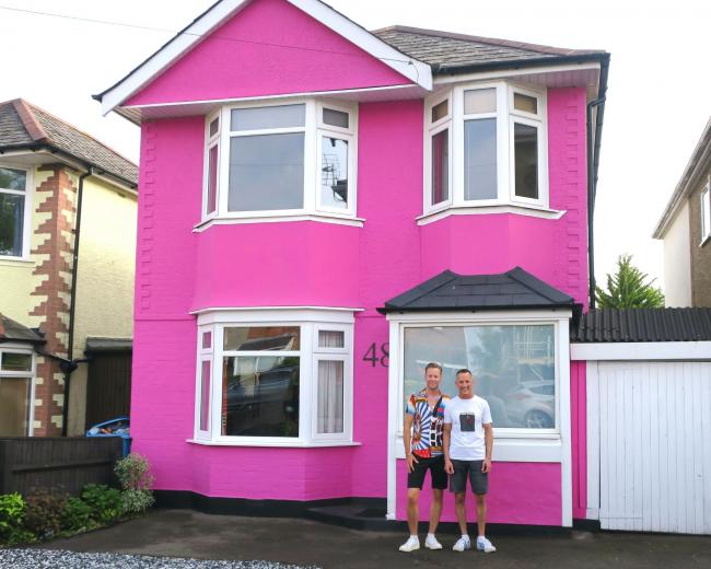 Grant Gould and Glen Butler (left to right) own the bright pink house that is cheering up commuters in Poole.