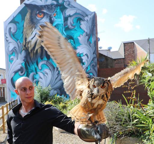Bournemouth Echo: Artist Krishna Malla – aka Tech Moon – with Elton the owl in front of his mural in Boscombe