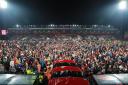 AFC Bournemouth supporters on the pitch at Vitality Stadium after promotion to the Premier League was secured. Picture: Richard Crease