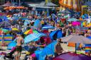 Beachgoers enjoying Weymouth's sunshine in July 2022.