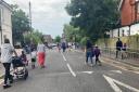 Parents and children in the temporarily closed road outside the entrance to St Clements & St Johns School, Boscombe, at school drop-off time