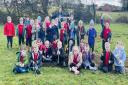 Outdoor learning helper Hannah Farmer with some of the children from Verwood Church of England First School and Nursery who have been planting new woodland at their school.