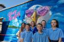 Children with the new Tech Moon mural at Stourfield Infant and Junior Schools.