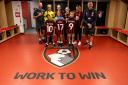 Eleanor, Leo and Sadie with AFCB players in the dressing room, with their new shirts.