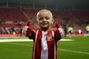 Bradley Lowery, aged five, who is terminally ill with cancer, stands on the pitch before the Premier League match at the Stadium of Light, Sunderland