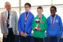Poole AC's William Rabjohns [in green] receives the English National Cross-Country Under-13 Boys Trophy