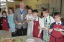 DISHING UP: Mayor of Christchurch, Cllr Peter Hall, with students from St Joseph’s Primary School