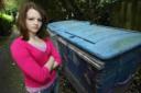 Christina Land, 16, in front of the bins