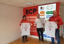 Operations Manager Wendy King and Merchandise Manager Paul Chapman, right, receiving printed t-shirts from BCP Media managing director Ian Shenton ahead of Paul's fundraiser