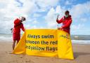 Rhyl RNLI Lifeguards George Davies and Matty Jones putting up windbreak. Picture: RNLI
