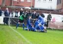 Brockenhurst's celebrations in the fourth-round win over local rivals New Milton (Pic: Steve Ross / @ThoseWhiteLines)
