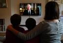 Ben, Isaac and Krystyna Rickett watching a broadcast of King Charles III first address to the nation as the new King following the death of Queen Elizabeth II on Thursday.