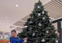 Forest Holme Hospice Charity Supporter Tiff Watson puts a star on the Tree of Remembrance