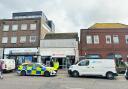 Police and forensics seen outside Santander after late night break-in.