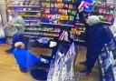 Male throwing shop products at duty manager, Christopher Charalambous (in grey), and another worker sat on floor
