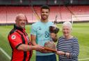 Kieran Chalker (left) and Sue Chalker (right) present Dominic Solanke (centre) with the Micky Cave Trophy
